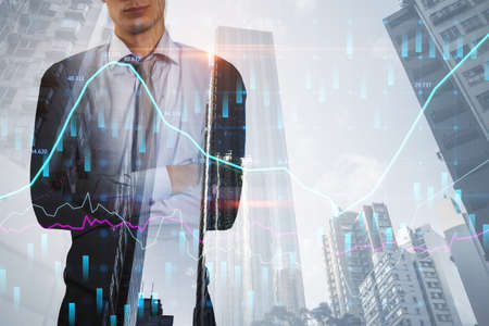 Headless young european businessman with folded arms standing on abstract bright city background...