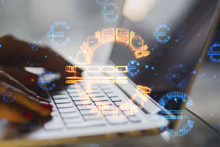 Close up of hands using laptop keyboard with abstract glowing euro sign hologram on blurry...