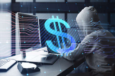 Side view of hacker at desktop using computers with glowing dollar hologram and lines on blurry office interior background. E-commerce, online banking, cryptocurrency and finance concept. double exposureの写真素材