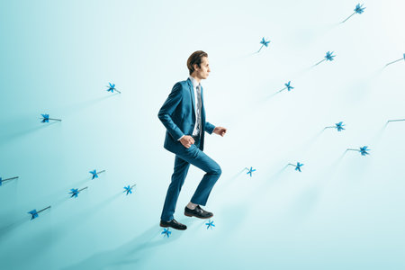 Attractive businessman in suit walking on abstract wall with many dart arrows. Goal setting and strategy conceptの写真素材