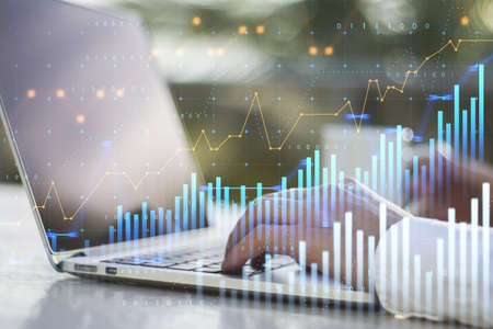 Close up of businessman hands using laptop with abstract glowing and growing business graph hologram...