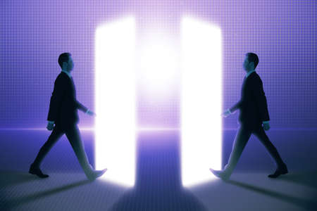 Side view of two young business men walking into metaverse world on glowing background. technology and innovation conceptの写真素材