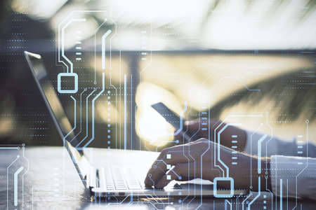 High-tech sensor circuit board panel. Close up of businessman hands using laptop and smartphone with hologram. Technology and digital communication concept on blurry outdoor background. double exposureの写真素材