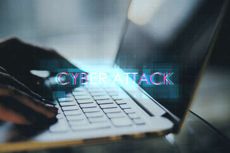Close up of hands using notebook keyboard with creative digital text hologram on blurry background. Cybr attack, technology and ai conceptの写真素材