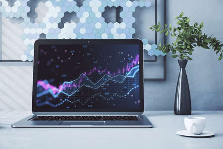 Close up of laptop with abstract glowing candlestick forex chart with index and grid on modern workplace backdrop with coffee cup. Invest, trade, finance ans stock market concept. 3D Renderingの写真素材