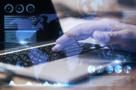 Close up of businessman hand using laptop keyboard with abstract map and business chart hologram on...