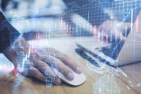 Close up of male hands using laptop keyboard with creative forex grid map on blurry background....