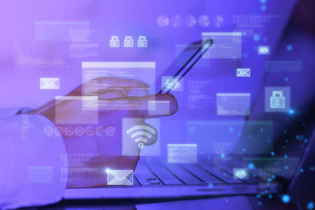 Close up of businessman hands using laptop and smartphone with abstract glowing digital...