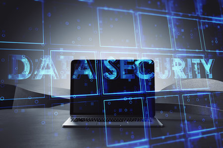 Close up of laptop computer with creative blue cubes data security text hologram on blurry...