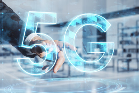 Close up of businessman hand pointing at abstract glowing 5G hologram on blurry office interior background. Mobile internet speed, communication and technology concept. double exposureの写真素材