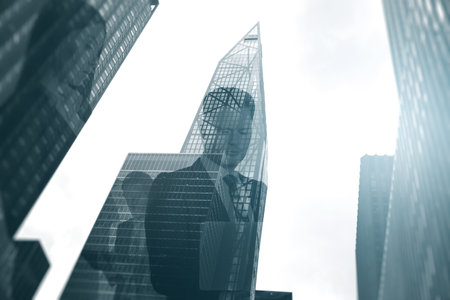 Abstract city with businesspeople silhouettes and bright white sky light. background image. Teamwork, success and meeting concept. double exposureの写真素材