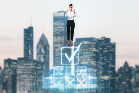 Attractive young european businesswoman standing on top of digital stairs to success on blurry city background and showing thumbs up. Futuristic goal achievement conceptの写真素材
