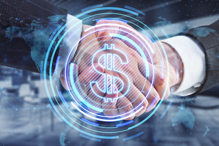 Close up of businessmen handshake with creative glowing round dollar icon and map hologram on blurry office interior background. Finance, teamwork, deal, currency and global business technologies concept. double exposureの写真素材
