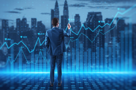 Attractive young european businessman with abstract glowing blue business graph hologram on blurry city background. Economy, finance and digital money concept. double exposureの写真素材