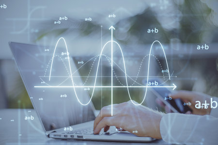 Close up of businessman hands using cellphone and laptop keyboard at desktop with abstract glowing mathematical formula graph on blurry background. Equation, digital data and mathematics app concept. double exposureの写真素材