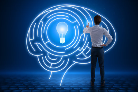 Back view of young european man using abstract digital light bulb with human brain inside glowing on...