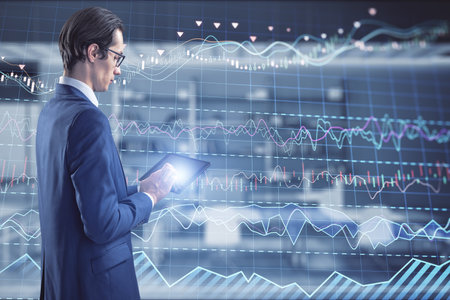 Attractive thoughtful caucasian businessman with pad and candle stick grid graph chart of stock...