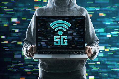 Close up of hacker hands holding laptop with 5G glitchy icon hologram on blurry background. 5th...