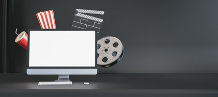 Online movie watching and cinematography concept with blank white modern computer monitor screen on empty dark cinema background with popcorn and film-strip. 3D rendering, mock upの写真素材