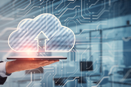 Close up of businessman hand holding tablet or smartphone with glowing cloud hologram on blurry office interior background. Server and data storage concept. double exposureの写真素材