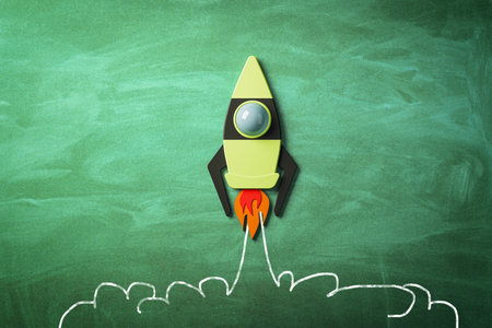 Startup and business concept with taking off bright graphic rocket on green chalkboard background....