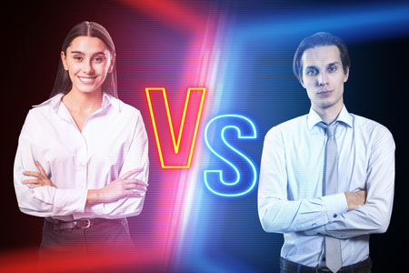 Attractive young businesswoman versus businessman on blurry dark neon background. Competition, battle and macth conceptの写真素材