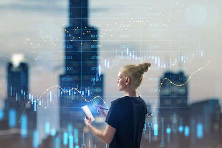Trade, finance and market concept. Attractive young blonde woman writing in glowing notepad on...