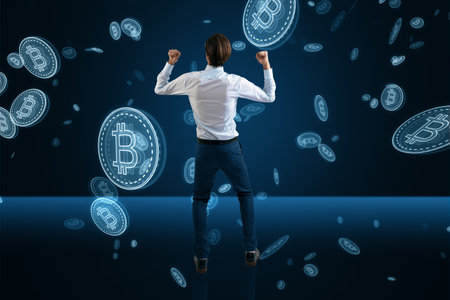 Business success, cryptocurrency and modern money earning concept with happy man back view on dark blue background under bitcoin rainの写真素材