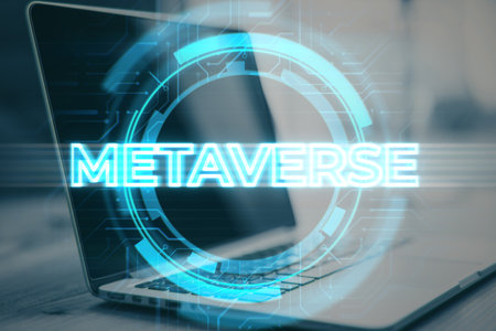 Close up of laptop on desktop with creative glowing metaverse background. Virtual reality and world concept. double exposureの写真素材