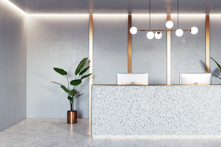 Front view on stylish reception desk with modern computers, golden wall decoration background, green plant on concrete floor and illuminated ceiling. 3D renderingの写真素材