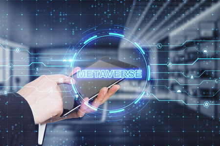 Close up of businessman hand pointing at tablet with glowing round circuit metaverse hologram on blurry office interior background. double exposureの写真素材
