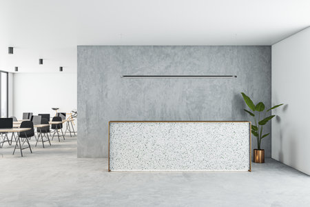 Front view on blank reception desk with space for product presentation on light concrete floor, gray wall and coworking office area on background. 3D rendering, mockupの写真素材