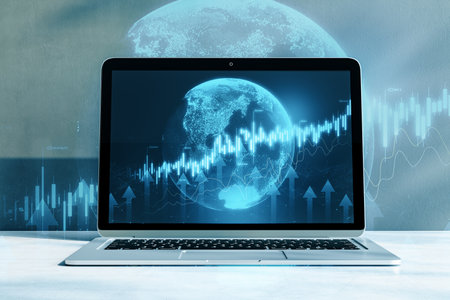 Close up of laptop with abstract globe and forex chart on blurry background. Finance statistics and data Analytics. Stock exchange market, investment, finance and trading. double exposureの写真素材