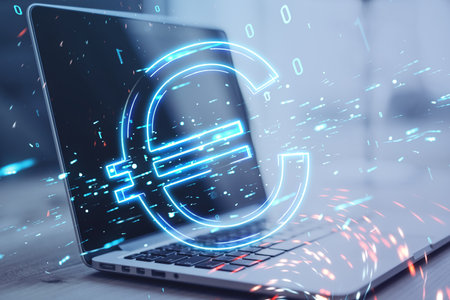 Close up of laptop on desktop with digital euro hologram on blurry background. Trade, finance and...
