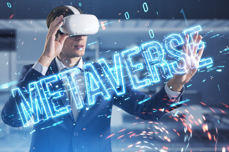 Attractive young businessman with VR glasses using glowing metaverse text hologram on blurry tech background. Digital world and future concept. double exposureの写真素材
