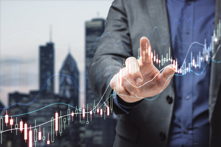 Close up of male hand pointing at glowing upward forex chart on blurry night city background. Trade, finance and stock concept. double exposureの写真素材