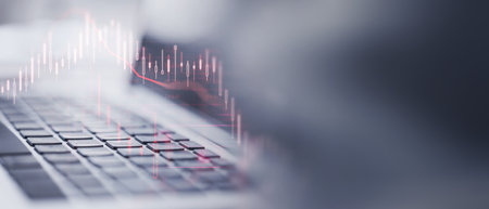 Close up of laptop keyboard with falling crisis financial forex chart on blurry wide background with...