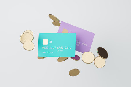 Top view of colorful credit or debit bank card and golden coins on light background. Discount, money and cashback concept. 3D Renderingの写真素材