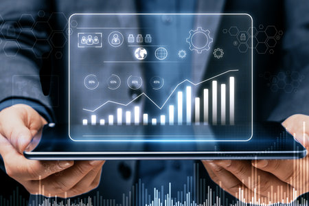 Close up of businessman hands holding tablet with glowing business chart hologram on blurry...