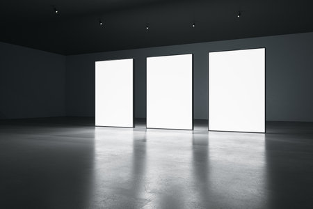 Three blank white glowing banners in dark hall interior with concrete floor and black walls. presentation concept. Mockup, 3D Renderingの写真素材