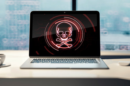 Laptop screen with skull and bones digital symbol on office wooden desk, hacking attack and piracy concept. 3D Renderingの写真素材