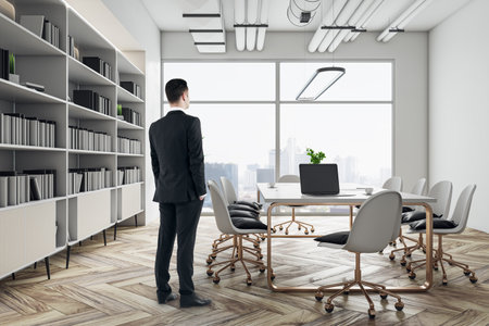 Work process with businessman back view in modern conference room interior design with white table and chairs on golden legs, wooden floor, huge bookshelf and city view background from big windowの写真素材