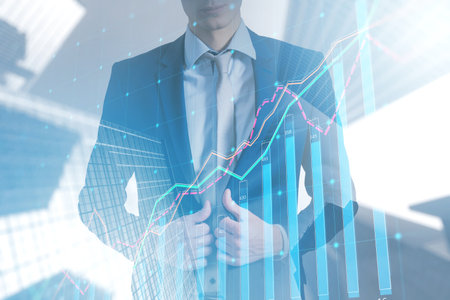Headless european businessman standing on toned city background with business chart. Finance and CEO concept. double exposureの写真素材
