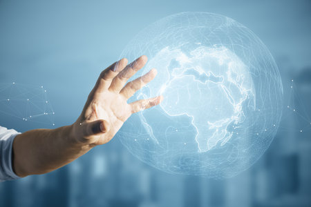 Close up of male hand using glowing polygonal globe on blurry city background. world map and earth conceptの写真素材