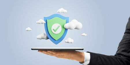 Close up of businessman hand holding cellphone with digital shield and clouds on light background. Secure online payment and data protection conceptの写真素材