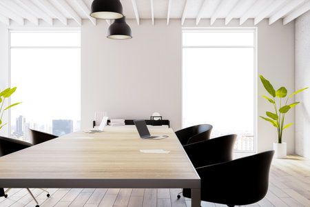 Closeup view of modern office coworking interior with large wooden desk, black armchairs, light...