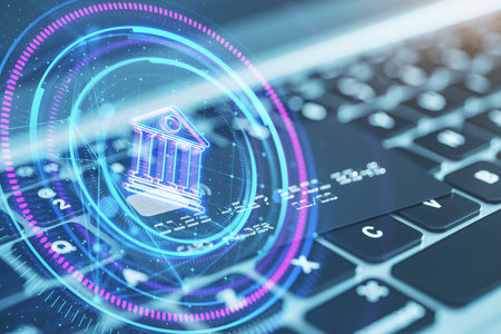 Close up of laptop keyboard with bank card and glowing round polygonal button with bank on blurry background. Online banking and money concept. Double exposureの写真素材