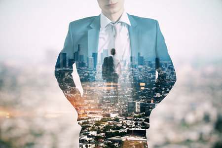 Young European businessman standing on abstract city background. Success, future and CEO concept. Double exposureの写真素材