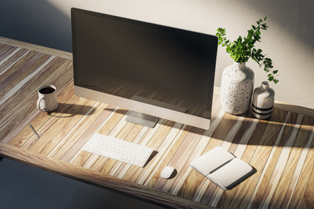 Close up of creative designer desk with empty computer screen, coffee cup, supplies and other items on concrete wall background. Workspace concept. Mock up, 3D Renderingの写真素材