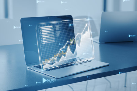 Holographic display of stock market trends on laptopの写真素材